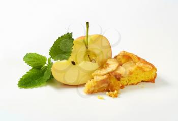 slice of homemade apple sponge cake and fresh apple on white background