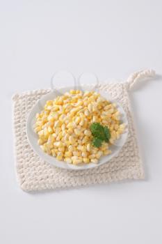 plate of sweet corn kernels on white table mat