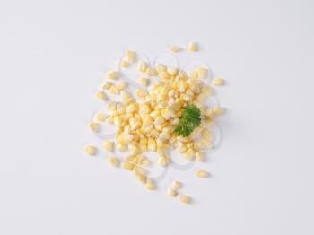 handful of sweet corn kernels on white background