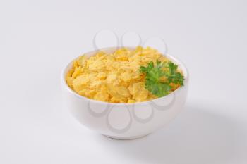 bowl of corn flakes on white background