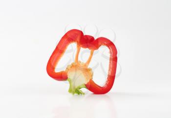 slice of red bell pepper on white background