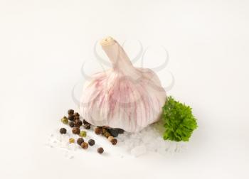 bulb of fresh garlic with spices on white background