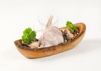 bowl of fresh garlic with spices on white background