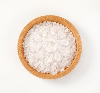 bowl of coarse grained salt on white background