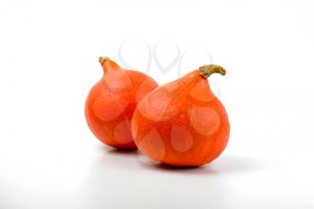 two small orange pumpkins on white background