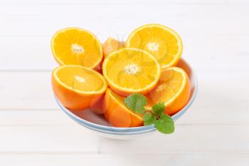 bowl of halved oranges on white background