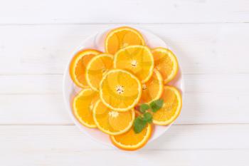 thin slices of fresh orange on white plate