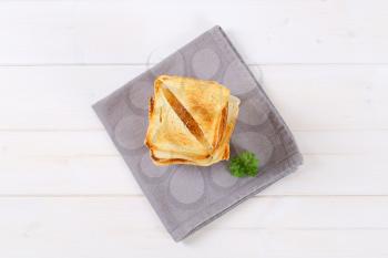 stack of toasted bread slices on grey place mat