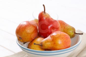 bowl of ripe red pears - close up