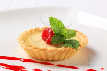 Custard tart topped with raspberry
