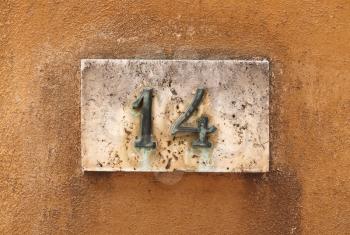 House number on a weathered wall