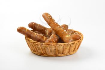 fresh bread rolls topped with salt and caraway seeds in bread basket