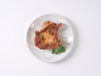roasted pork cutlet on white plate