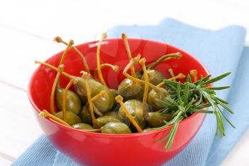 bowl of pickled caper berries with stems on
