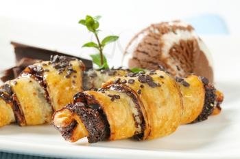 detail of chocolate chip croissants with scoop of ice cream on white plate