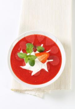 Bowl of chilled strawberry soup with cream