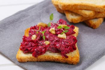 toast with beetroot spread on grey place mat - close up