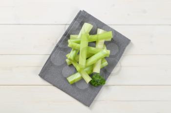 stems of green celery on grey place mat