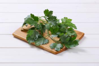 fresh parsley leaves on wooden cutting board