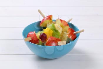 fresh fruit skewers in turquoise bowl