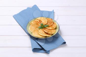 plate of fresh american pancakes on blue place mat