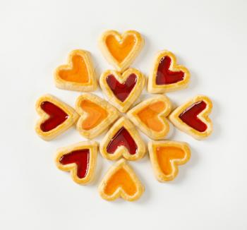 Heart shaped shortbread cookies with apricot and cherry jam filling
