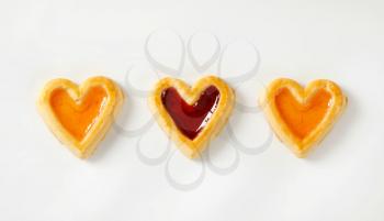 Heart shaped shortbread cookies with apricot and cherry jam filling