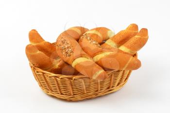 scuttle of fresh bread rolls on white background - close up