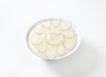bowl of semolina pudding on white background