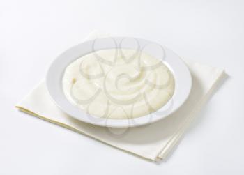 plate of semolina pudding on white napkin