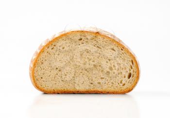 Half a loaf of moist continental bread on a white background
