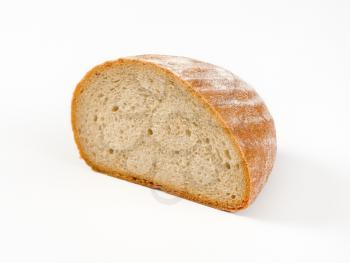 Half a loaf of continental bread on a white background