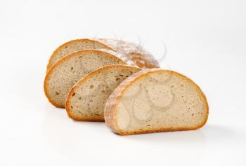 Sliced continental bread on a white background