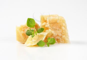 Pieces of Parmesan cheese on white background