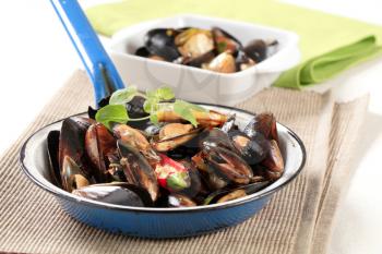 Delicious steamed mussels on a frying pan