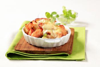 Fish and potato casserole topped with cheese