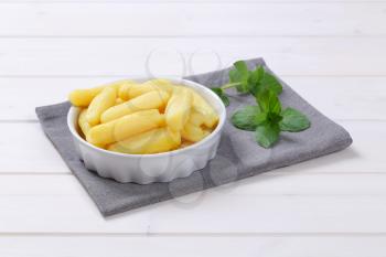 bowl of cooked potato cones or gnocchi on grey place mat