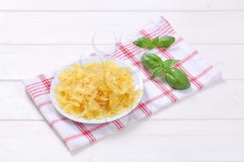 plate of quadretti - square shaped pasta on checkered dishtowel