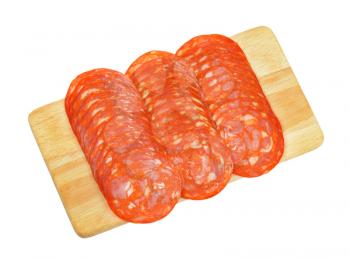 slices of chorizo salami ranked on wooden cutting board
