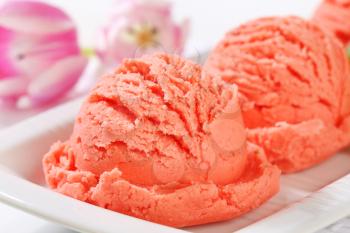 Scoops of pink fruit sherbet on long plate
