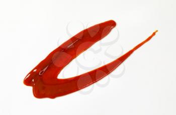 red drizzle sauce on white background