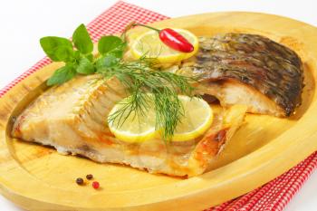 Oven baked carp fillets with lemon and herbs