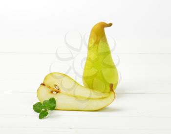 one and half pears on white wooden background