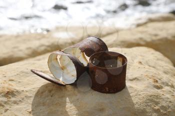 Old rusty cans left on the sea shore