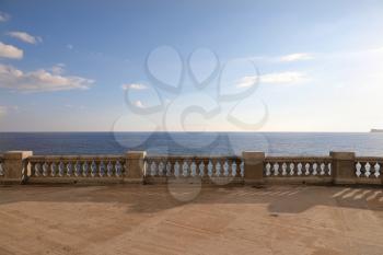 View from a terrace with old stone balustrade overlooking the sea