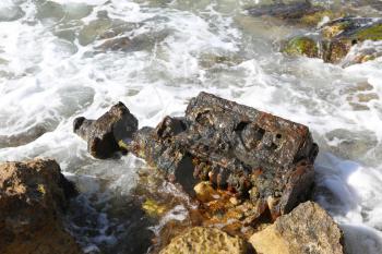 Rusty piece of iron washed up on the sea shore