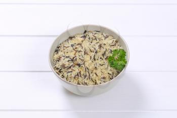 bowl of wild rice on white wooden background