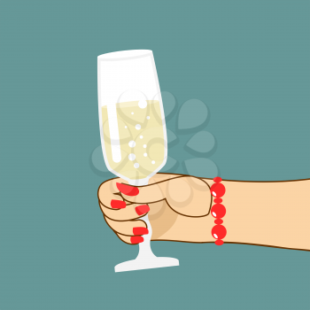 Womans hand with  glass of champagne. Woman holds wine. Red fingernails and bracelet.
