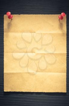 folded note paper on wooden background