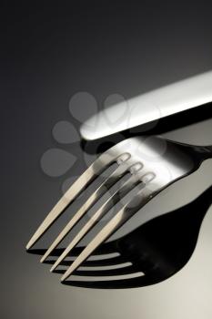 knife and fork on black background